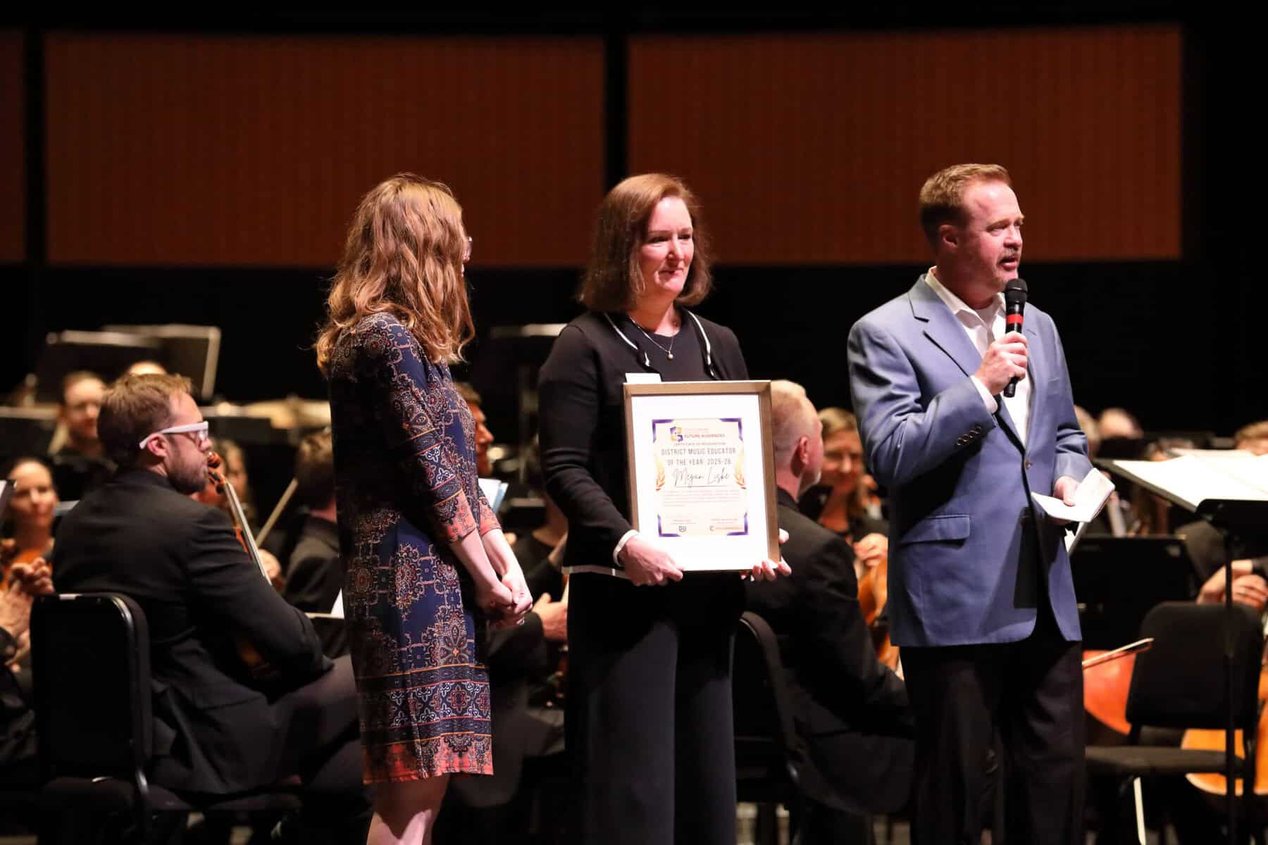 Megan Liske (left) being awarded the District Teacher of the Year from Kim Kincaid (middle) and Nathan Newbrough (right).