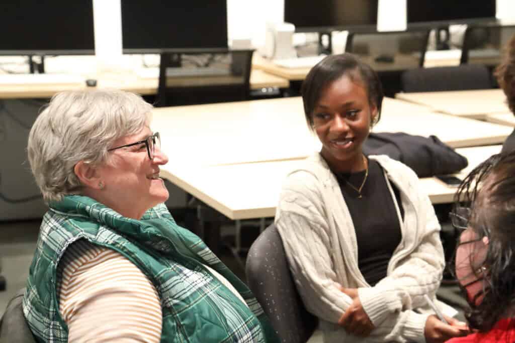 Two participants in the seatmates programs happily conversing